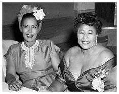 two women sitting next to each other at a table