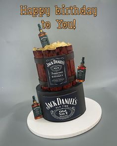 a birthday cake made to look like a barrel with liquor bottles on it and the words happy birthday to you