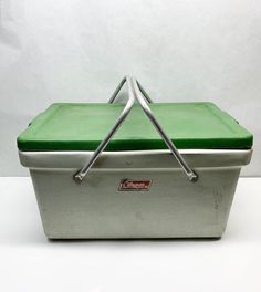 a green and white cooler sitting on top of a table