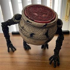 an odd looking bowl sitting on top of a wooden table