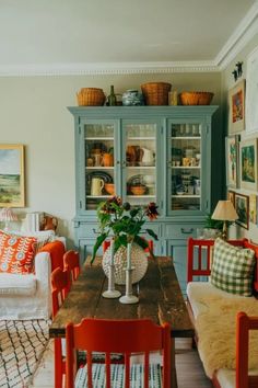 a dining room table with chairs and a hutch in the backround area