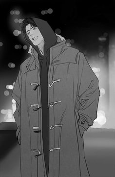 a man wearing a coat and hood standing in front of a building with lights behind him