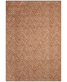 an orange and white rug with chevrons on the bottom, in different colors