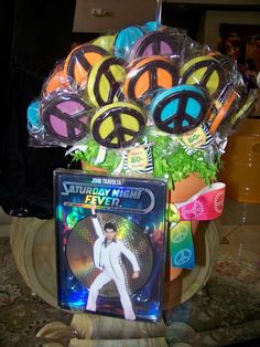 a bunch of peace signs are in a vase with some dvd's on it