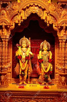 two statues of hindu deities on display in a temple stock photo - 957982