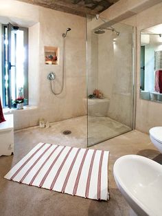 a bathroom with a shower, sink and bathtub next to a window in it