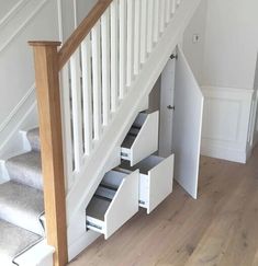 an open staircase with drawers underneath it