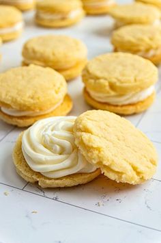 several cookies with frosting on top sitting on a table