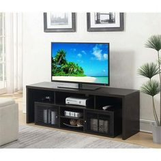 a flat screen tv sitting on top of a black entertainment center