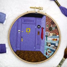 a purple door is in the middle of a room with some yarn and scissors on the floor