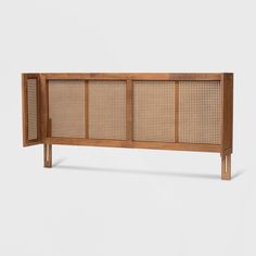 the sideboard is made out of wood and has wicker panels on each side