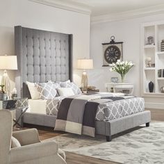 a bedroom with a bed, chairs and pictures on the wall