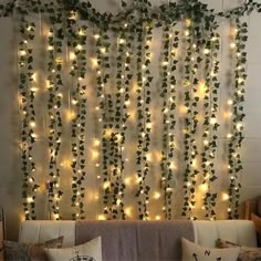 a living room filled with lots of lights and greenery hanging on the side of the wall