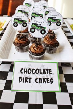 there are cupcakes with chocolate frosting in the shape of trucks on them