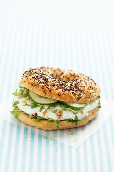 a bagel sandwich with cucumber and cream cheese