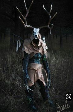 a man dressed up as a deer in the dark