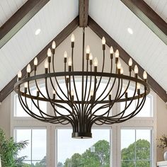 a large chandelier hanging from the ceiling in a room with high ceilings and windows