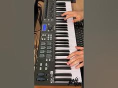 two hands are playing an electronic keyboard