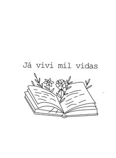 an open book sitting on top of a table next to a small flower and leaves