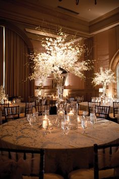 an elegant table with candles and centerpieces is set up for a formal function