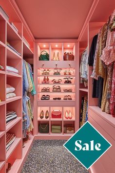 a walk in closet with pink walls and shelving