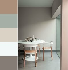 a dining room table and chairs in front of a wall with color swatches on it