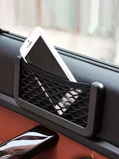 a cell phone in a holder on the dashboard of a car