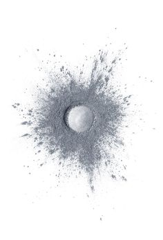 an object is shown in black and white, with some powder sprinkles around it