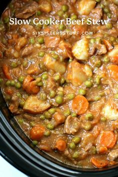 a crock pot filled with carrots, peas and meat in gravy