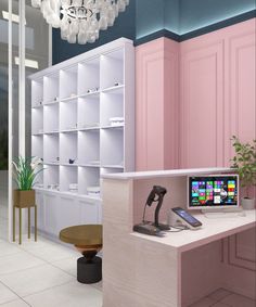 a computer desk with a phone on it in front of a bookcase and shelves