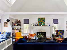 a living room filled with furniture and a fire place in the middle of a room