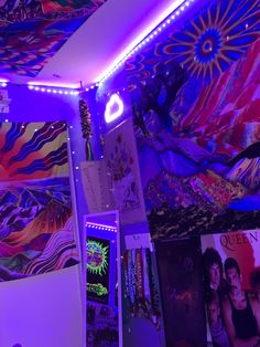 the ceiling is covered in colorful lights and posters on it, along with other art work