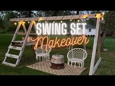 a swing set makeover sign is lit up on the grass in front of a house