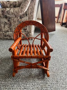 a wooden chair sitting on top of a carpeted floor