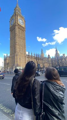 two women are standing in front of big ben