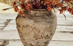 a vase with some flowers in it sitting on a table