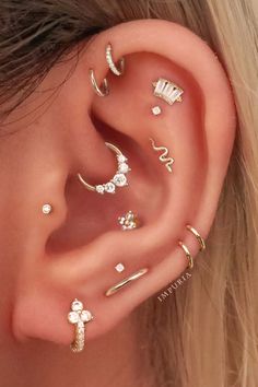 an ear with five different piercings on it, including one for the nose and two for