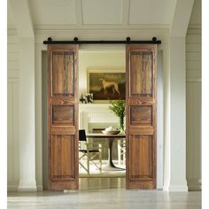 an open wooden door leading to a dining room