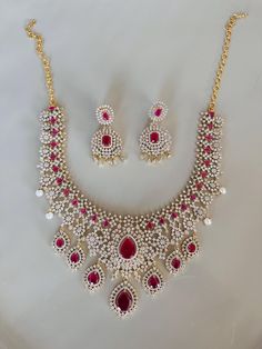 Indian Jewelry Set made with ruby-colored stones and pearls. Perfect for the Indian Bride Indian Jewelry Set, Indian Bridal Jewelry, Spiritual Necklace, Indian Bridal Jewelry Sets, Bride Necklace, Bridal Jewelry Set, Indian Jewelry Sets, Colored Stones, Tree Necklace