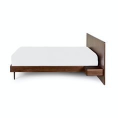 a bed with a wooden headboard and foot board on top of it, against a white background