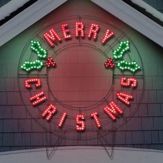 a lighted merry christmas sign on the side of a building