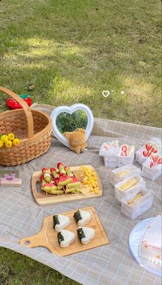 a picnic table with food and snacks on it in the shape of heart shaped boxes