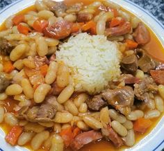 a white plate topped with rice and beans