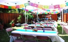 an outdoor party setup with tables and chairs