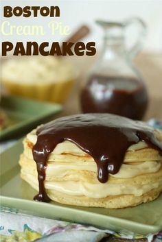 boston cream pie pancakes with chocolate drizzled on top, sitting on a green plate