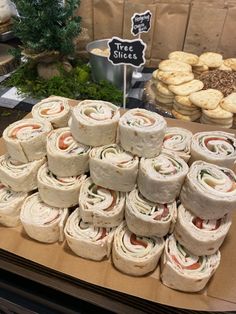 a table topped with lots of sandwiches and cookies