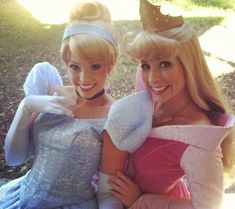 two women dressed as princesses posing for a photo