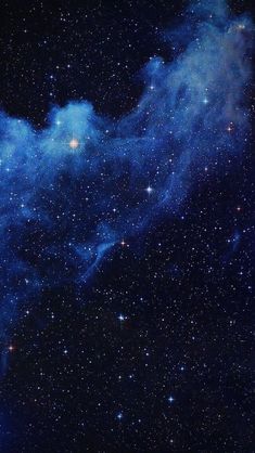 the night sky is filled with stars and blue dust, as well as some clouds