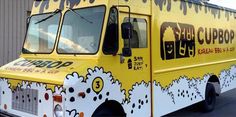 an ice cream truck is painted yellow and white with the words big cuppop on it