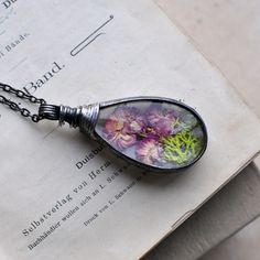 "Want to know more about me? Thank you Etsy for featuring me! https://blog.etsy.com/en/featured-shop-mariaela/ Photos are example of the product.  Pendants can vary slightly, because in nature there are no two the same flowers. I try to choose lasting species of flowers. Lovely terrarium necklace by MARIAELA. One of a kind. Fern is locked into glass forever. Convex glass makes a loupe effect. I'm trying to show that on my photos. I adore to picking and drying flowers. In my jewelery are placed flowers which I have picked from meadows and my garden. I try to choose lasting species of flowers. All of my jewelry is created in my home studio. Handmade with love ♥. Tifanny method - eco friendly tin. The length of necklace with grummet is 6,4 cm or 2,5 inches. The necklace is made from convex gl Drying Flowers, Know More About Me, Boho Chic Bracelets, Terrarium Jewelry, Terrarium Necklace, Modern Hippie, Rose Necklace, Rose Jewelry, Chunky Rings